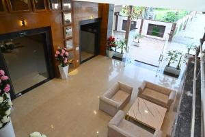 an overhead view of a lobby with two chairs and flowers at Hotel Vasdaa Grand in Dehradun