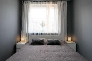 מיטה או מיטות בחדר ב-Apartament Baltica Gdańsk