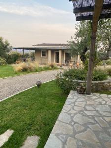 a backyard with a stone walkway and a house at Moi country villa in Agios Nikolaos