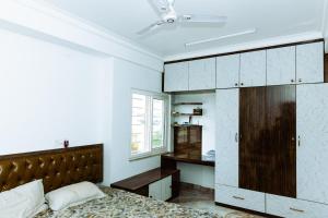 a bedroom with a bed and a desk at RVR Home - Beautiful Rooms in Bangalore