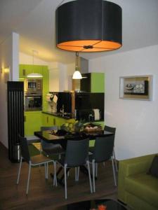 a kitchen and dining room with a table and chairs at As Casinhas de Loureda in Arcos de Valdevez