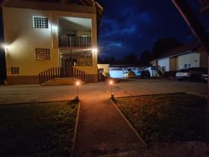 a house at night with lights in the yard at House Mesić in Smoljanac