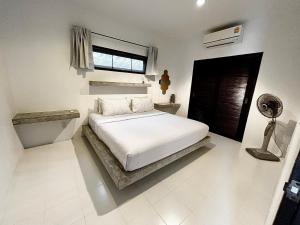 a white bedroom with a bed and a window at Koh Tao Studios 47 in Ko Tao +48 photos