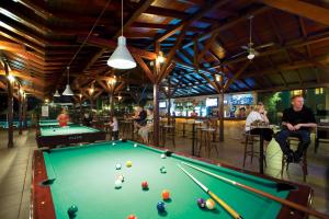 a pool table in a bar with people playing pool at Julian Club Hotel in Marmaris