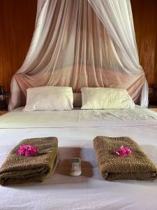 a bed with two baskets on top of it at Banana cottages in Gili Air