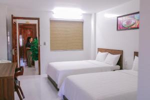 Un pat sau paturi într-o cameră la Vagibi Hotel