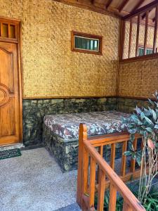 a room with a bed in the corner of a building at Banana cottages in Gili Air