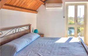 a bedroom with a large bed and a window at Casa Chappell in Badolato