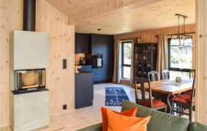 a kitchen and dining room with a table in a tiny house at 4 Bedroom Beautiful Home In Sjusjen in Sjusjøen