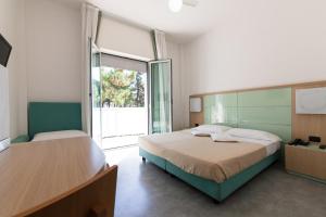 Postel nebo postele na pokoji v ubytování Hotel Sahara