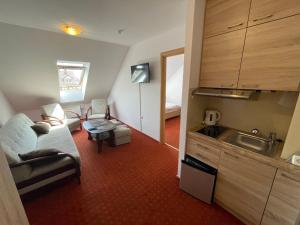 a small kitchen with a couch and a table in a room at Willa Milano in Mielno
