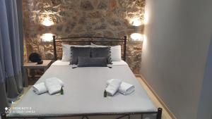 a bedroom with a bed with two towels on it at Villa in the Olive Trees in Galaxidhion