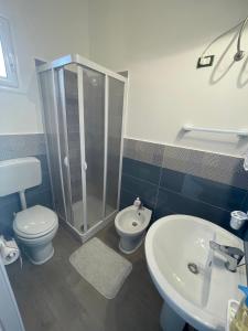 a bathroom with a shower and a toilet and a sink at B&B Rose Antiche Sicily in Partinico