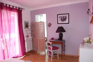 a room with a desk and a table with a chair at Les Chambres de Kerzerho in Erdeven