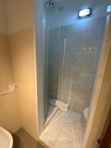 a bathroom with a glass shower with a toilet at Hotel Naviglio in Marina di Pietrasanta