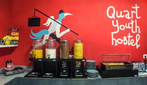 a counter with some food and a red wall at Quart Youth Hostel & Apartments in Valencia