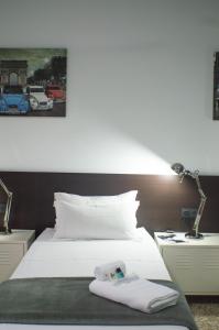 a bedroom with a bed with a towel on it at Quart Youth Hostel & Apartments in Valencia