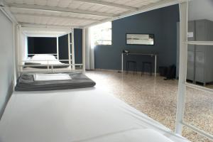 a room with two beds and a desk in it at Quart Youth Hostel & Apartments in Valencia