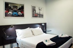 a bedroom with a bed with two towels on it at Quart Youth Hostel & Apartments in Valencia