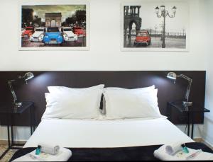a bedroom with a white bed with two lamps at Quart Youth Hostel & Apartments in Valencia