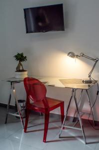 a red chair sitting next to a desk with a lamp at Quart Youth Hostel & Apartments in Valencia
