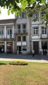 uma mulher a andar em frente a um edifício em Casa Augusta AL em Braga
