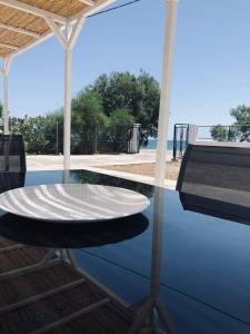 a reflection of a table in a pool of water at Mini Villas Avra in Keratokampos