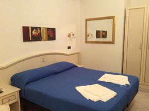 Postel nebo postele na pokoji v ubytování Hotel La Zorza