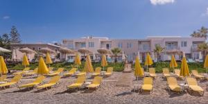 a group of chairs and umbrellas on a beach at Solimar Turquoise - Adults Only in Agia Marina Nea Kydonias
