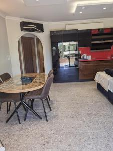 a dining room with a table and chairs and a bedroom at Red in Vlikhón