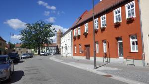 an empty street in a town with orange buildings at Ferienwohnung Große / Werner in Jüterbog