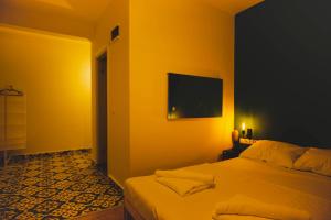 a bedroom with a bed and a flat screen tv at Belsun Hotel in Beldibi