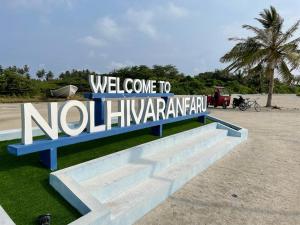 a sign that says welcome to noilipengarma at Ocean Voice Beach Resort & Diving in Nolhivaranfaru