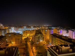 a city at night with buildings and lights at Armação de Pêra Vista Mar in Armação de Pêra