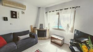 ein Wohnzimmer mit einem Sofa und einem Kamin in der Unterkunft Villa Puccini: Luxury villa with private pool in Peyia