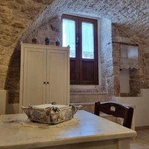 a kitchen with a table with a bowl on it at La tana degli Incerti in Alberobello
