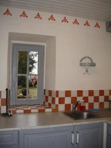 cocina con fregadero y ventana en Au Château Juillac, en Juillac