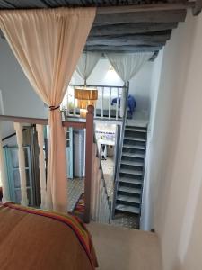 a room with a staircase leading up to a bedroom at RIAD MAROSKO in Essaouira