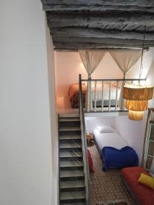 a room with a bunk bed and a staircase at RIAD MAROSKO in Essaouira