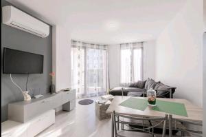 a living room with a table and a couch at Moderna Apartment in Burgas City