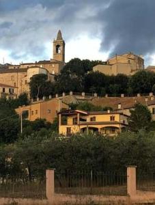 un edificio con una torre de reloj en una colina en b&b Casa Regina, en Stroncone