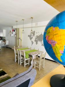 a dining room with a table and a world on the wall at Real Home in Ruffano