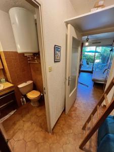 a bathroom with a toilet and a sink and a staircase at Studio climatisé avec jardin et plage à 250m in Saint-Mandrier-sur-Mer