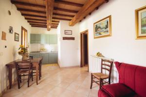 a kitchen and dining room with a table and chairs at Agriturismo Le Giare in Bagno Roselle