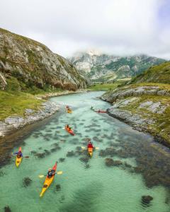 a group of people in kayaks on a river at Gulbrakka Basecamp in Glomfjord