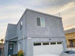 a gray house with a white garage at Modern Hostel in Los Angeles