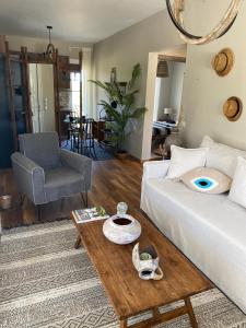 a living room with a white couch and a table at Moi country villa in Agios Nikolaos