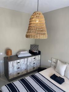 a bedroom with a bed and a chandelier at Moi country villa in Agios Nikolaos