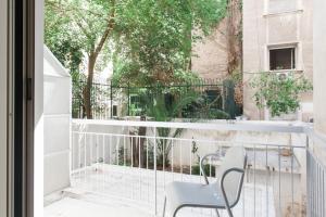 a balcony with a chair and a table at Neat Kolonaki apartment, Athens city centre - NV8 in Athens