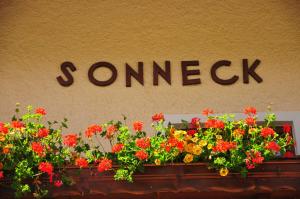 a sign that says somck above a bunch of flowers at Chalet Sonneck in Seefeld in Tirol